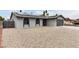 Single-story house featuring stucco siding, arched windows, solar panels, and low-maintenance gravel landscaping at 4416 Rip Van Winkle Ln, Las Vegas, NV 89102