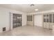 Bright living room featuring tile flooring, large glass sliding doors, and built in storage at 4416 Rip Van Winkle Ln, Las Vegas, NV 89102