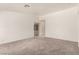 Spacious living room featuring neutral carpet, base trim, and light walls at 4416 Rip Van Winkle Ln, Las Vegas, NV 89102