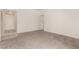 Spacious living room featuring neutral carpet, base trim, and an entry door at 4416 Rip Van Winkle Ln, Las Vegas, NV 89102