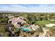 Breathtaking aerial view of a golf community featuring a pool, clubhouse, and pristine golf course at 4908 Winterset Dr, Las Vegas, NV 89130