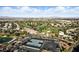 Wide aerial shot of the neighborhood showcasing tennis courts, golf course and landscaping at 4908 Winterset Dr, Las Vegas, NV 89130