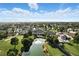 Picturesque aerial view of a neighborhood featuring a pond, golf course, and mature trees at 4908 Winterset Dr, Las Vegas, NV 89130