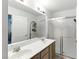 Bathroom featuring a double vanity sink, large mirror, and updated sliding glass shower doors at 4908 Winterset Dr, Las Vegas, NV 89130