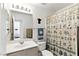 Cozy bathroom with a floral shower curtain, white sink, and a matching toilet at 4908 Winterset Dr, Las Vegas, NV 89130
