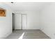 A clean, minimalist bedroom featuring light wood floors and a double closet at 4908 Winterset Dr, Las Vegas, NV 89130