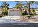Charming single-story home featuring a two-car garage and well-manicured landscaping at 4908 Winterset Dr, Las Vegas, NV 89130