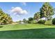 Scenic view of the golf course with a water feature and well-manicured greens at 4908 Winterset Dr, Las Vegas, NV 89130