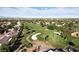 Bird's-eye view of the golf course, complete with lush greens, mature trees, and desert landscaping at 4908 Winterset Dr, Las Vegas, NV 89130