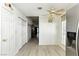 Hallway with hardwood floors, white walls, and doors with gold hardware at 4908 Winterset Dr, Las Vegas, NV 89130