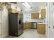 Functional kitchen with stainless steel appliances, wooden cabinets, and light-colored flooring at 4908 Winterset Dr, Las Vegas, NV 89130