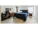 Spacious primary bedroom with light wood floors, two windows, and stylish decor at 4908 Winterset Dr, Las Vegas, NV 89130