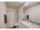Well lit bathroom featuring granite countertops, white cabinets, and a shower and bathtub combo at 5617 Craftsman Ave, Las Vegas, NV 89122
