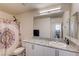 Bathroom featuring granite countertops, white cabinets, and a shower with decorative curtain at 5617 Craftsman Ave, Las Vegas, NV 89122