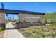 Independence Planned Community entrance featuring stone signage and colorful landscaping at 5617 Craftsman Ave, Las Vegas, NV 89122
