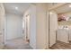 Hallway with carpet and white walls; laundry room is visible to the right at 5617 Craftsman Ave, Las Vegas, NV 89122