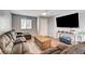 Cozy living room featuring a comfortable sectional sofa and a large television at 5617 Craftsman Ave, Las Vegas, NV 89122