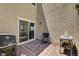 Cozy patio with brick flooring, an outdoor grill, a small chair, and access to the inside at 5617 Craftsman Ave, Las Vegas, NV 89122