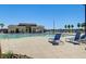 Large community swimming pool featuring blue lounge chairs and palm trees at 5617 Craftsman Ave, Las Vegas, NV 89122