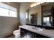 Bright bathroom features a dark vanity with a solid surface top and tile backsplash at 6 Yorkridge Ct, Henderson, NV 89052