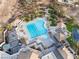 An aerial view shows the large swimming pool, sun loungers, and umbrellas at 6 Yorkridge Ct, Henderson, NV 89052
