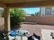 View of backyard with patio, brick retaining wall, decorative rock, and lush landscaping at 7064 Coventry Glenn Rd, Las Vegas, NV 89148