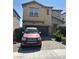Two-story home showcasing a well-maintained yard and charming architectural details at 7064 Coventry Glenn Rd, Las Vegas, NV 89148