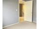 Neutral bedroom with wall to wall carpet and a view to the hall with an open door at 8089 Windmill Villa St, Las Vegas, NV 89139