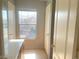 Hallway view with a window and linen closet near the bathroom, offering extra storage at 8089 Windmill Villa St, Las Vegas, NV 89139