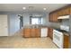 Kitchen with tile floors and backsplash, stainless appliances, and wooden cabinets at 8089 Windmill Villa St, Las Vegas, NV 89139