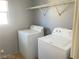 Functional laundry room with washer, dryer, and overhead shelf at 8089 Windmill Villa St, Las Vegas, NV 89139
