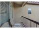 Balcony with two cushioned chairs and wrought iron railing at 8325 Winterchase Pl, Las Vegas, NV 89143