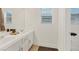 Elegant bathroom with double sink vanity, white cabinets, and modern fixtures at 8325 Winterchase Pl, Las Vegas, NV 89143