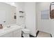 Clean white bathroom featuring modern fixtures, open shelves, and a glass enclosed shower at 8325 Winterchase Pl, Las Vegas, NV 89143