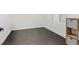 Clean bedroom with dark floors, a window, and a shelf with storage boxes at 8325 Winterchase Pl, Las Vegas, NV 89143