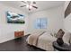 Well-lit bedroom features dark wood floors, ceiling fan, and mounted television at 8325 Winterchase Pl, Las Vegas, NV 89143