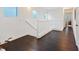 Upstairs hallway with dark wood floors and white banister at 8325 Winterchase Pl, Las Vegas, NV 89143