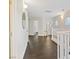 Second floor hallway with dark wood floors and white banister at 8325 Winterchase Pl, Las Vegas, NV 89143