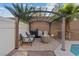 Relaxing outdoor patio with a fire pit and comfortable seating under a pergola at 8325 Winterchase Pl, Las Vegas, NV 89143