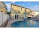 Backyard featuring a refreshing swimming pool and a view of the two-story home at 8325 Winterchase Pl, Las Vegas, NV 89143