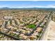 Wide aerial shot shows a well-planned community with greenery, desert landscape, and views of the Las Vegas skyline at 8929 Monte Oro Dr, Las Vegas, NV 89131