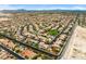 Vast aerial view of a well-planned community with green spaces,desert landscaping, and mountain views at 8929 Monte Oro Dr, Las Vegas, NV 89131