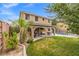Two-story home with a covered patio, lush lawn, and a refreshing pool in the backyard at 8929 Monte Oro Dr, Las Vegas, NV 89131