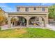 Inviting covered backyard patio with a built-in barbecue, ample seating and manicured lawn at 8929 Monte Oro Dr, Las Vegas, NV 89131