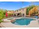 Exterior shot featuring a stunning pool, in-ground spa, covered patio, and desert landscaping at 8929 Monte Oro Dr, Las Vegas, NV 89131