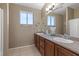Bathroom featuring double sinks, granite countertops, and a well-lit mirror at 8929 Monte Oro Dr, Las Vegas, NV 89131
