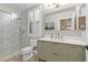This bathroom features a glass enclosed shower, and a vanity with gold hardware and matching mirror at 8929 Monte Oro Dr, Las Vegas, NV 89131