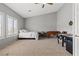 Neutral bedroom featuring a comfy bed, large windows with shutters, and game tables at 8929 Monte Oro Dr, Las Vegas, NV 89131