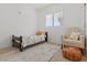 Cozy bedroom with natural light, stylish chair, and comfortable rug at 8929 Monte Oro Dr, Las Vegas, NV 89131