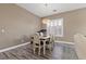 Cozy dining room features a wood table, four chairs, and modern light fixture at 8929 Monte Oro Dr, Las Vegas, NV 89131